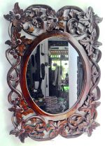 Carved oval wall mirror